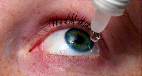 Woman Putting Drops In Eyes